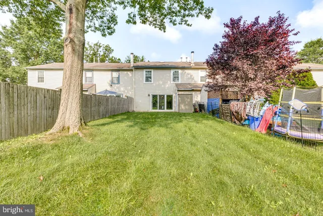 a view of a house with a backyard and a patio