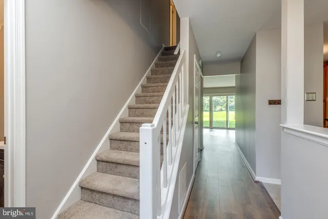 a view of entryway and hall with wooden floor