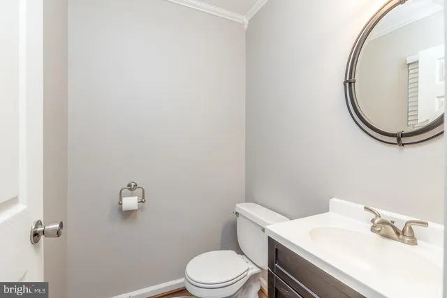 a white toilet sitting next to a bathroom sink