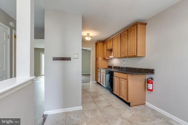 a kitchen with stainless steel appliances granite countertop a refrigerator and a stove