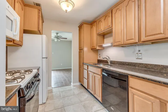 a kitchen with stainless steel appliances granite countertop a stove and a sink