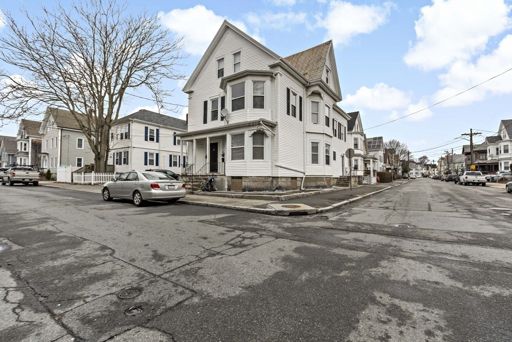 69 Locust Street New Bedford, MA 02740 - Photo 1 of 40 a view of a street with buildings