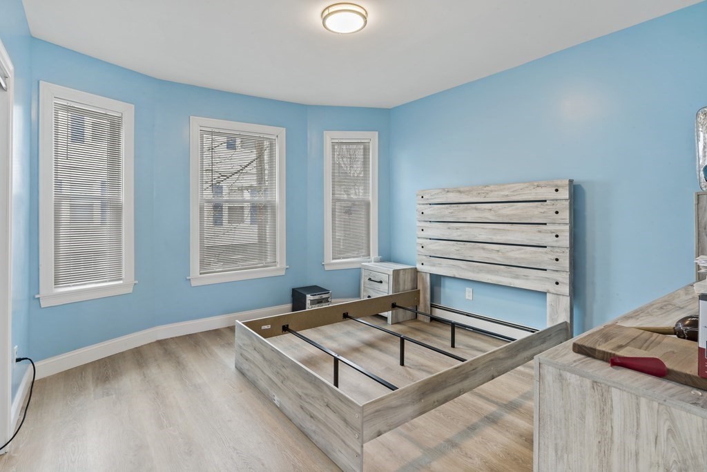 69 Locust Street New Bedford, MA 02740 - Photo 11 of 40 a living room with hard wood floors and a window