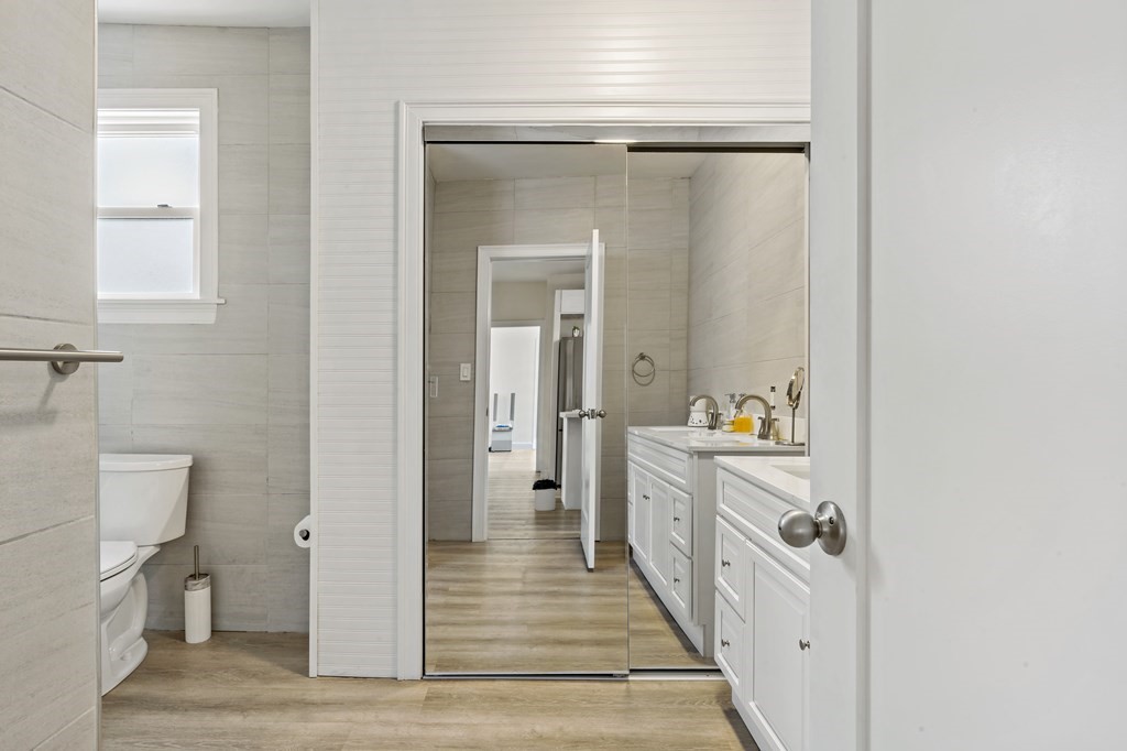 69 Locust Street New Bedford, MA 02740 - Photo 18 of 40 a bathroom with a sink and mirror with toilet