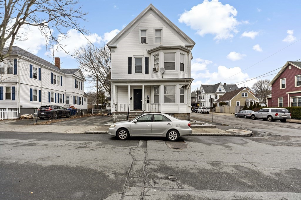 69 Locust Street New Bedford, MA 02740 - Photo 2 of 40 a view of a street that has couple of cars parked on the road