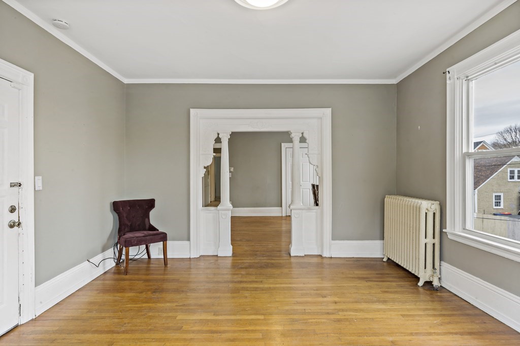 69 Locust Street New Bedford, MA 02740 - Photo 21 of 40 a hallway with chairs and wooden floor