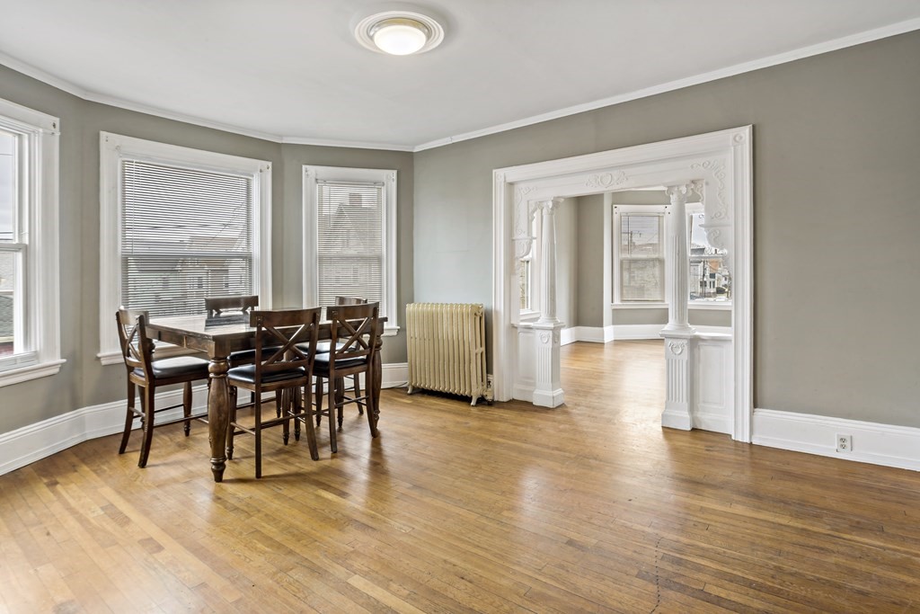 69 Locust Street New Bedford, MA 02740 - Photo 23 of 40 a view of a dining room with furniture and wooden floor