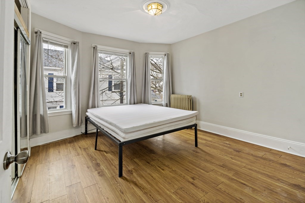 69 Locust Street New Bedford, MA 02740 - Photo 24 of 40 a view of a room with wooden floor and window