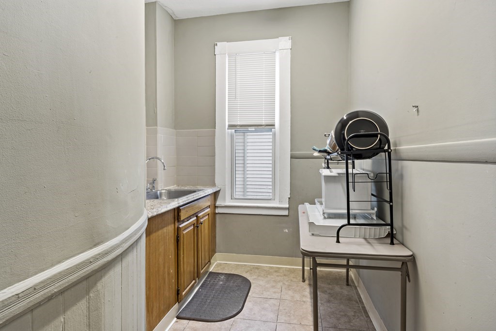 69 Locust Street New Bedford, MA 02740 - Photo 28 of 40 a view of a bathroom with a sink and mirror