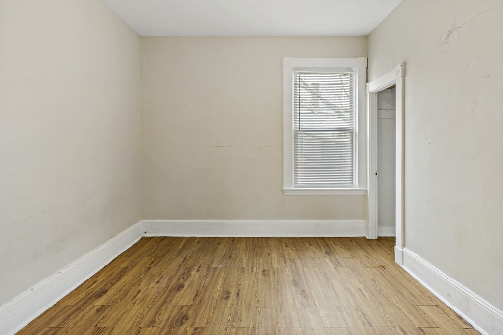 69 Locust Street New Bedford, MA 02740 - Photo 29 of 40 a view of a room with wooden floor and window