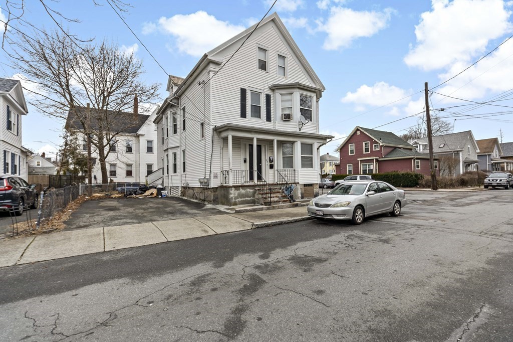 69 Locust Street New Bedford, MA 02740 - Photo 3 of 40 a view of cars parked in front of a house
