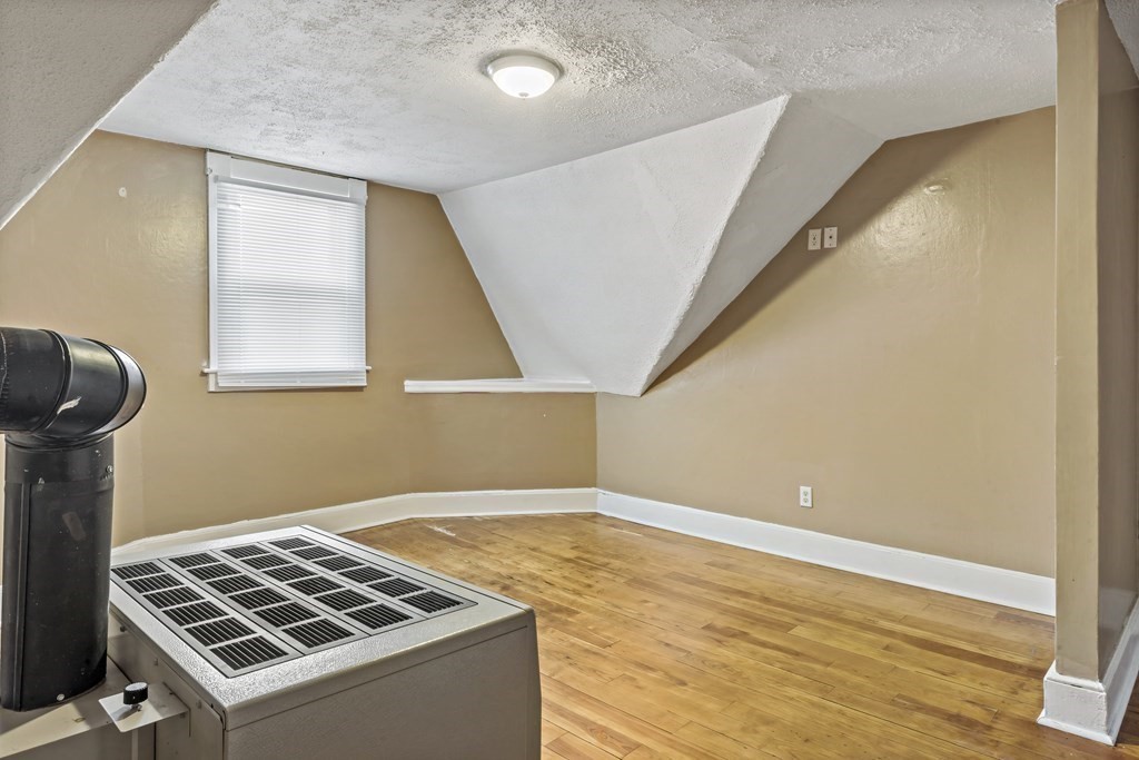 69 Locust Street New Bedford, MA 02740 - Photo 34 of 40 a view of a livingroom with wooden floor and windows