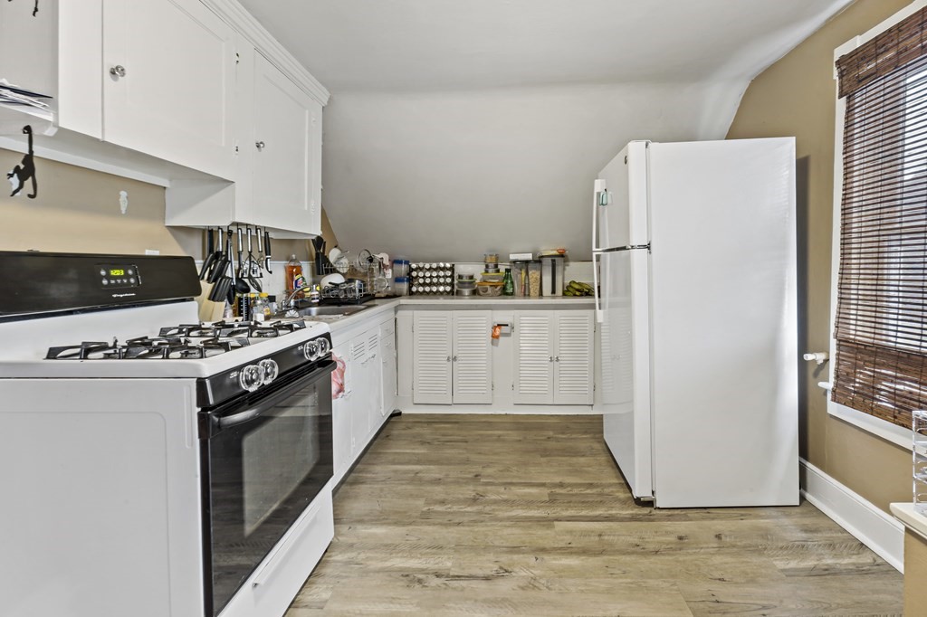 69 Locust Street New Bedford, MA 02740 - Photo 40 of 40 a kitchen with stainless steel appliances a refrigerator and a stove