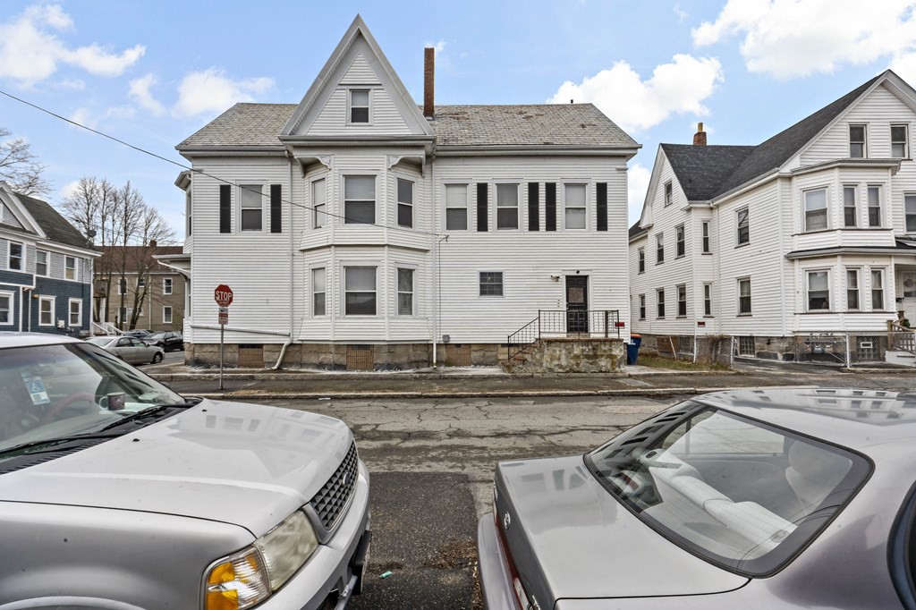 69 Locust Street New Bedford, MA 02740 - Photo 4 of 40 a view of a white house with swimming pool and furniture