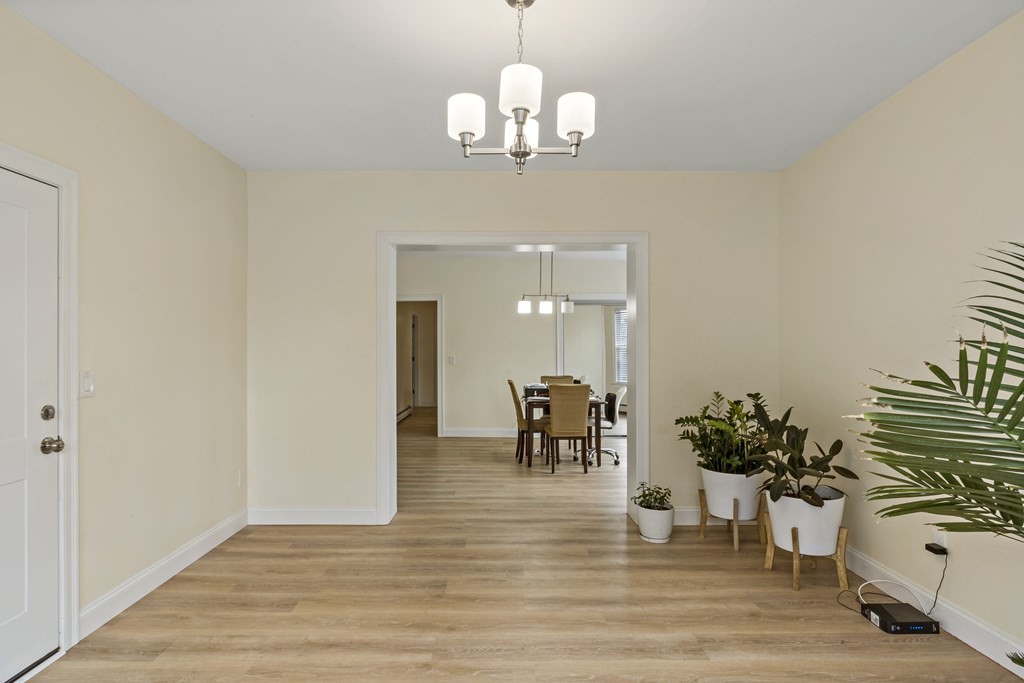 69 Locust Street New Bedford, MA 02740 - Photo 6 of 40 a view of a dining room with furniture and wooden floor