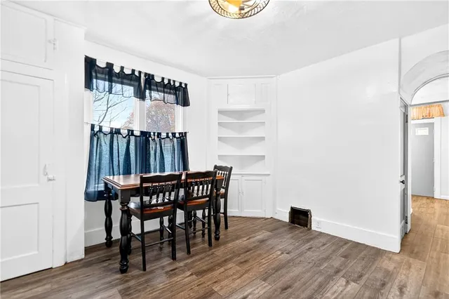 a kitchen with a sink cabinets and wooden floor