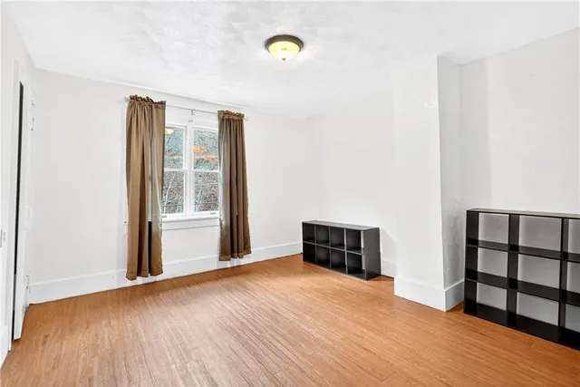 a view of a room with wooden floor