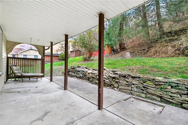 a balcony with furniture and a potted plant