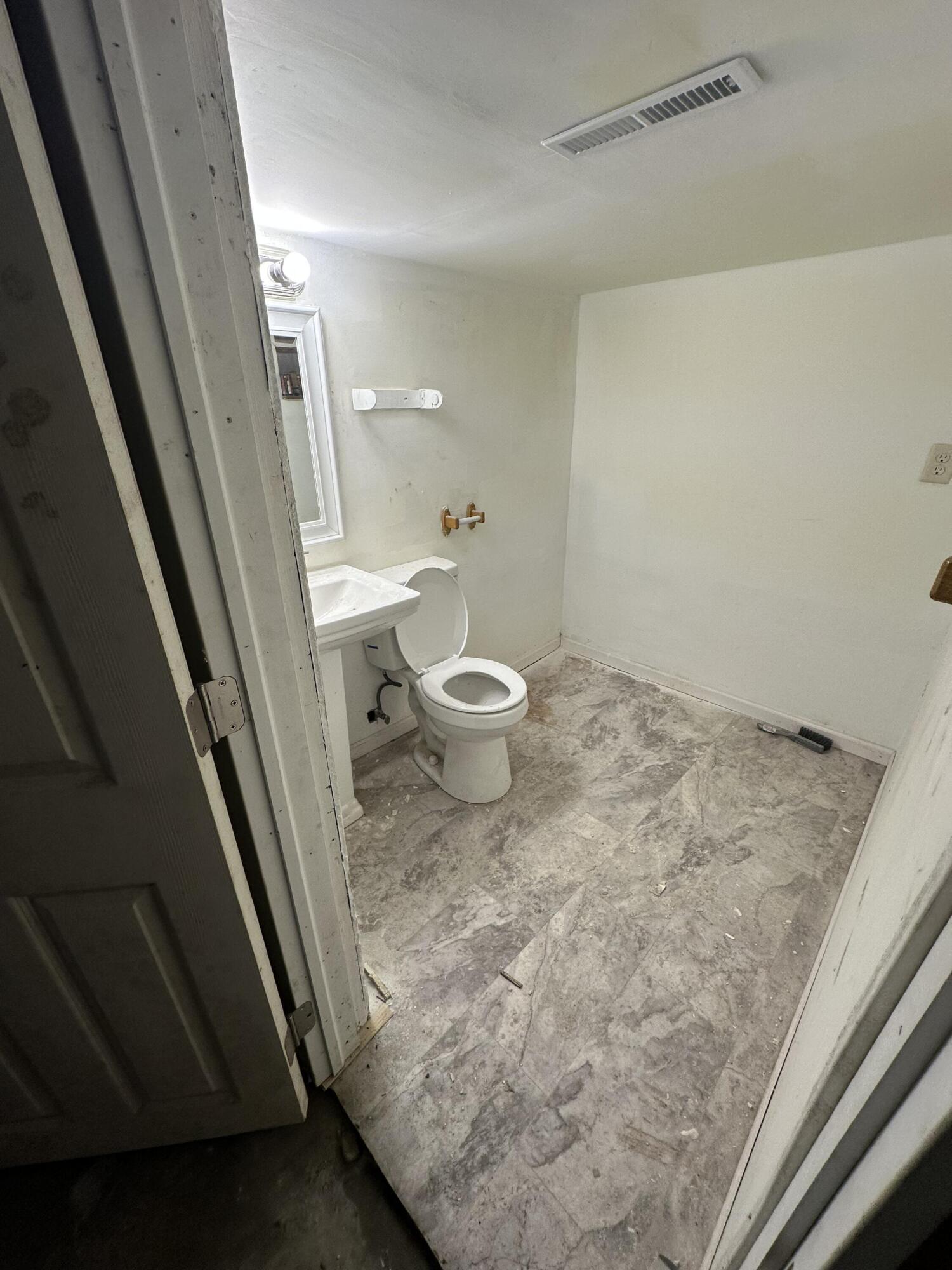 2371 Monroe Street Gary, IN 46407 - Photo 11 of 17 a bathroom with a granite countertop sink and a toilet