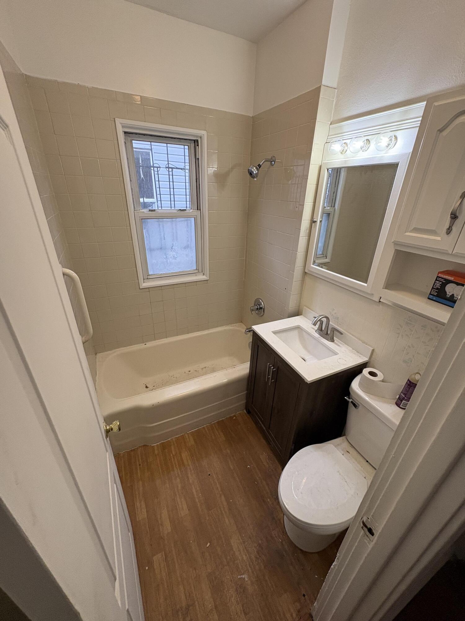 2371 Monroe Street Gary, IN 46407 - Photo 4 of 17 a bathroom with a bathtub sink mirror vanity and toilet