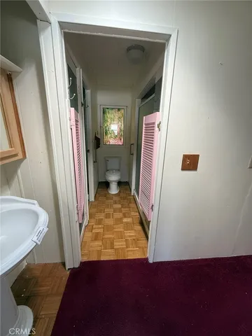 an empty room with a ceiling fan and carpet