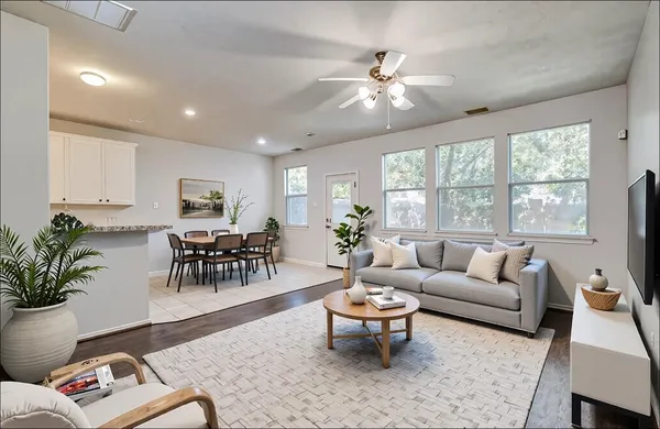 a living room with furniture and wooden floor