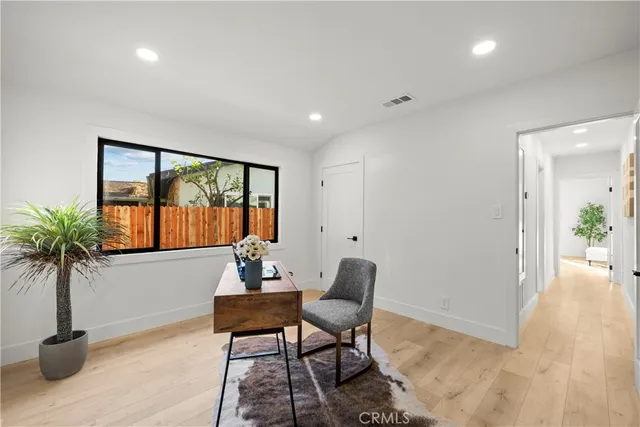 a living room with furniture and flowers