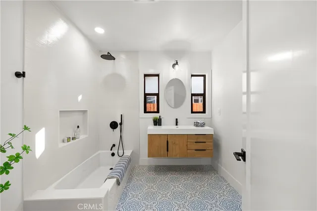 a bedroom with a large bed and a potted plant