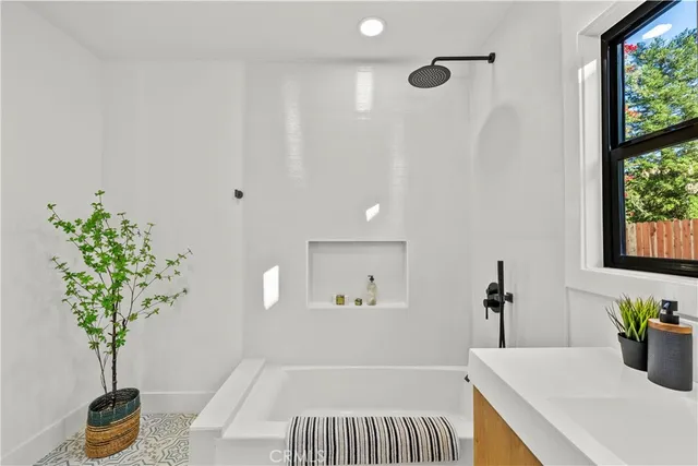 a bedroom with a bed and a plant