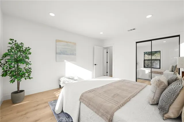 a bedroom with a bed lamp and a fireplace