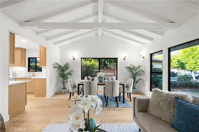 a living room with furniture a fireplace and a chandelier
