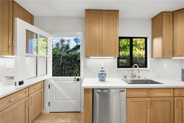 a kitchen with a sink a stove a microwave and wooden cabinets
