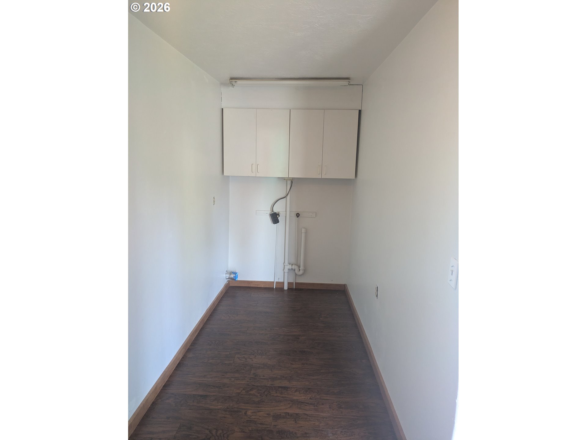 1116 7th Street Florence, OR 97439 - Photo 2 of 15 a view of a hallway with wooden floor