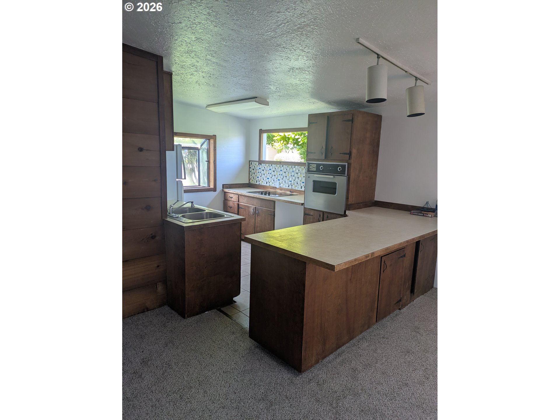 1116 7th Street Florence, OR 97439 - Photo 5 of 15 a kitchen with stainless steel appliances granite countertop a sink and a stove