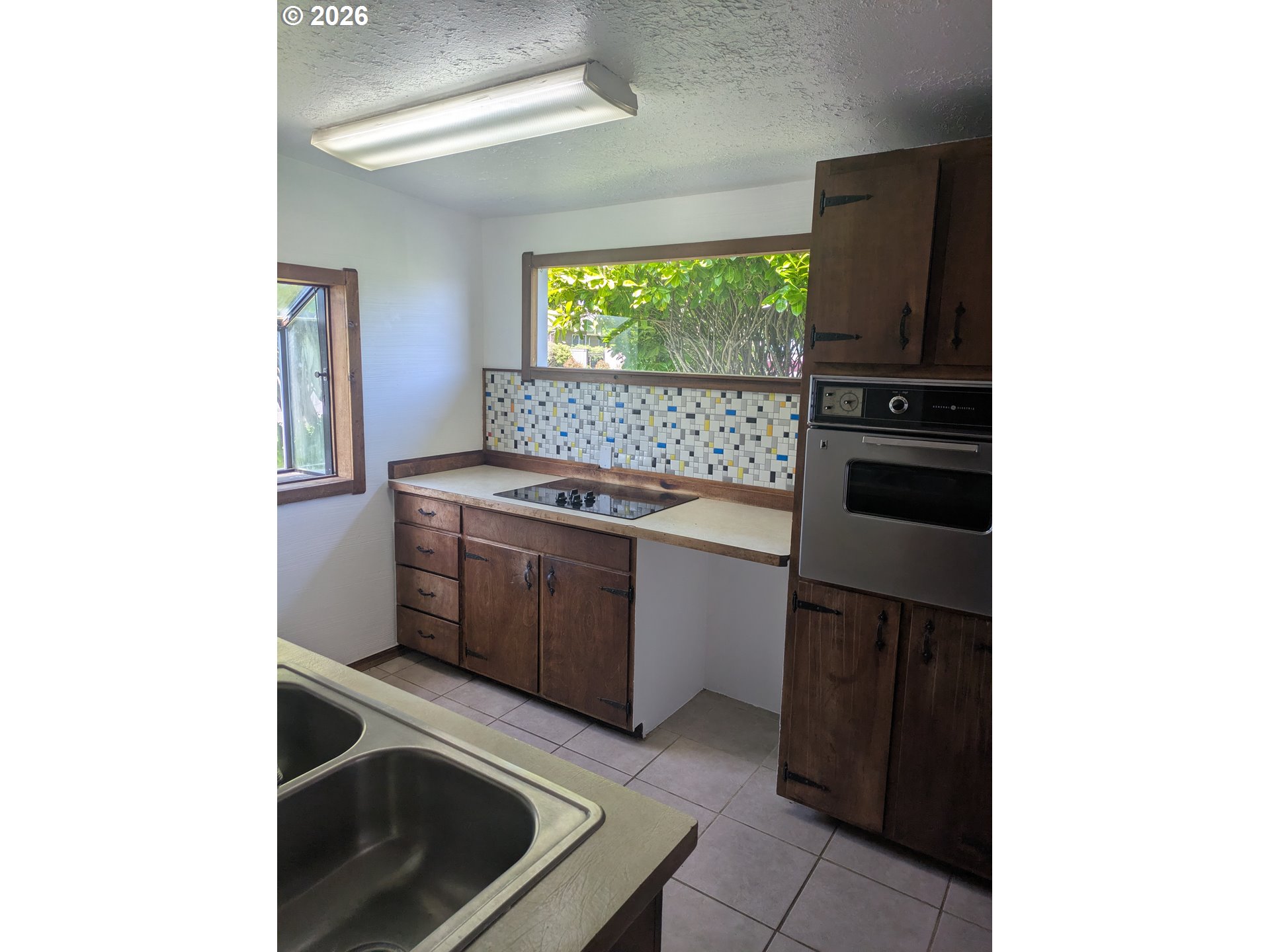 1116 7th Street Florence, OR 97439 - Photo 6 of 15 a kitchen with a stove and a microwave