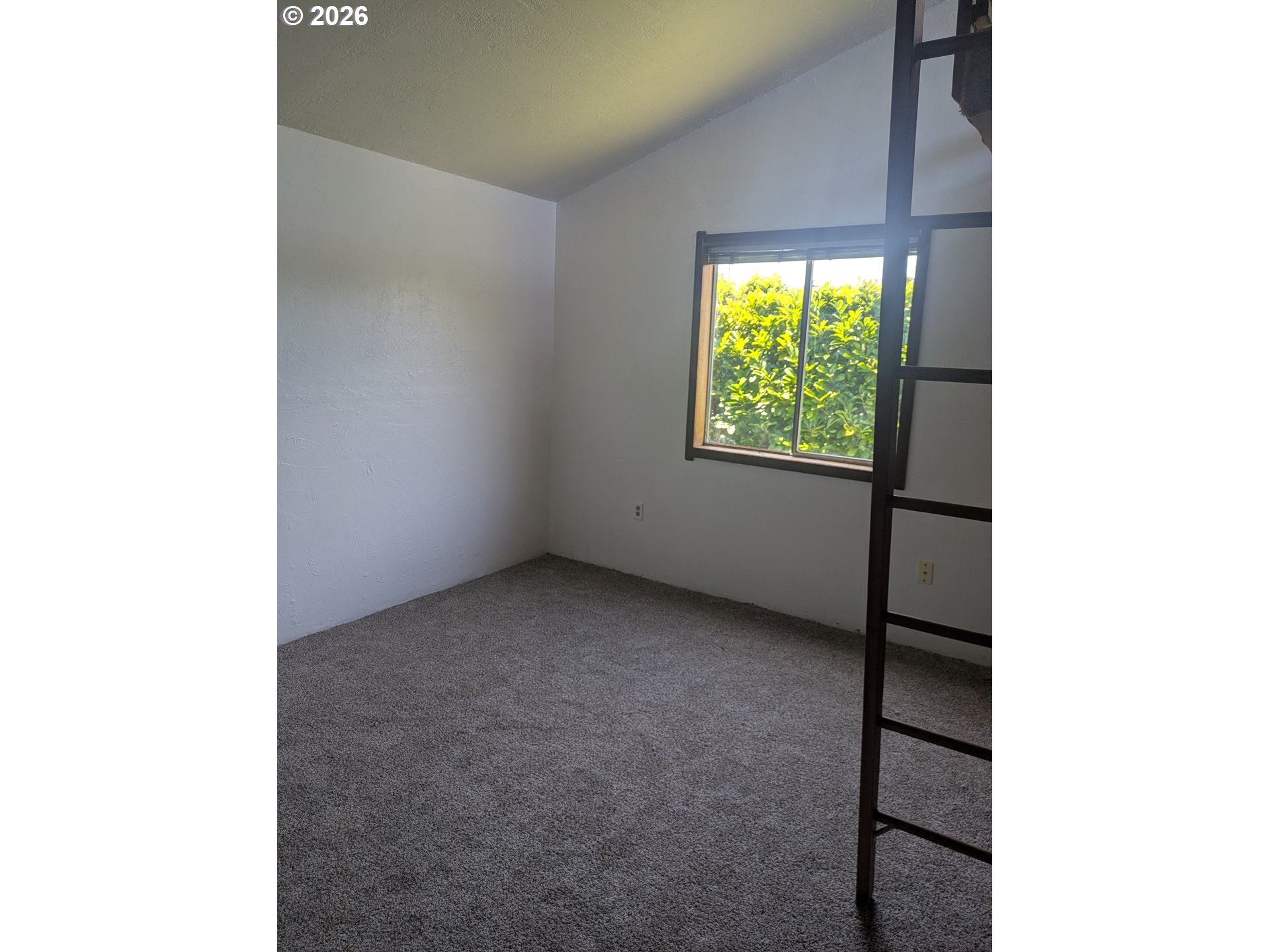 1116 7th Street Florence, OR 97439 - Photo 8 of 15 a view of an empty room with a window