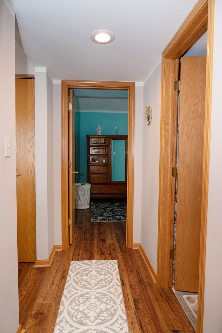 18124 Rita Road, Unit 2C Tinley Park, IL 60477 - Photo 13 of 23 a view of a hallway with wooden floor and a bathroom