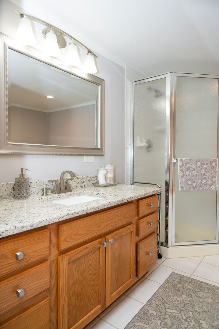 18124 Rita Road, Unit 2C Tinley Park, IL 60477 - Photo 16 of 23 a bathroom with a granite countertop sink and a mirror