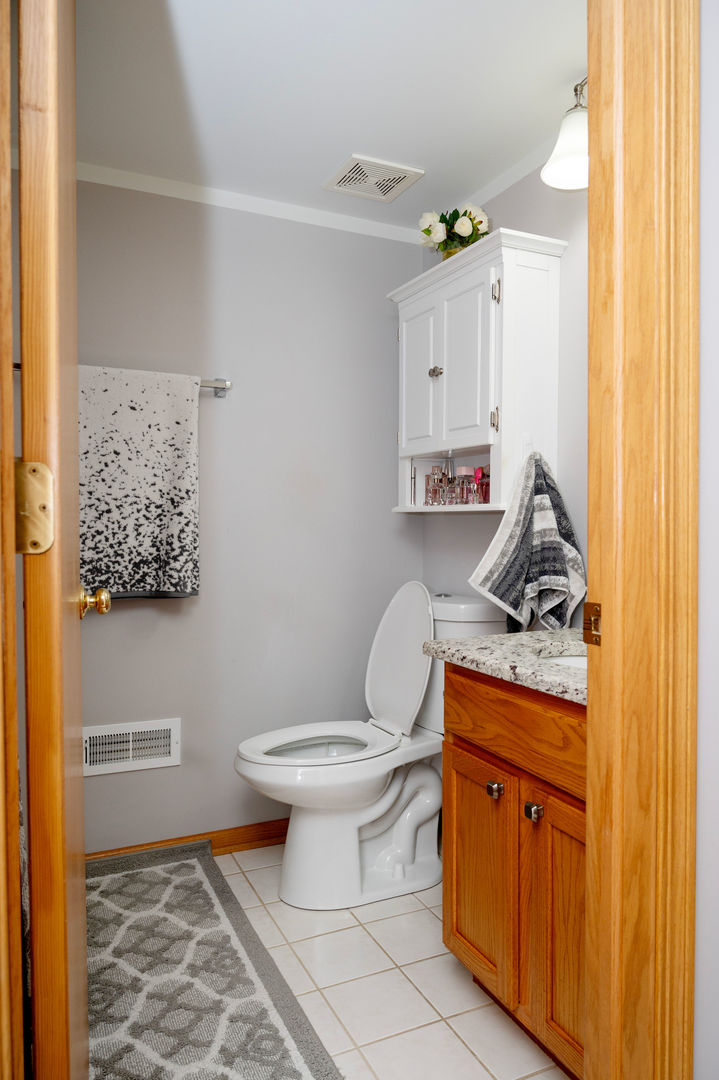 18124 Rita Road, Unit 2C Tinley Park, IL 60477 - Photo 19 of 23 a bathroom with a toilet sink and mirror