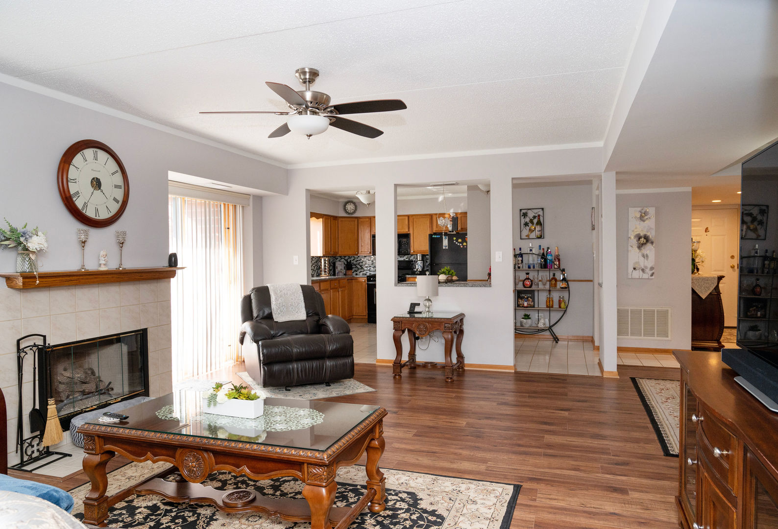 18124 Rita Road, Unit 2C Tinley Park, IL 60477 - Photo 4 of 23 a living room with furniture a clock and a fireplace
