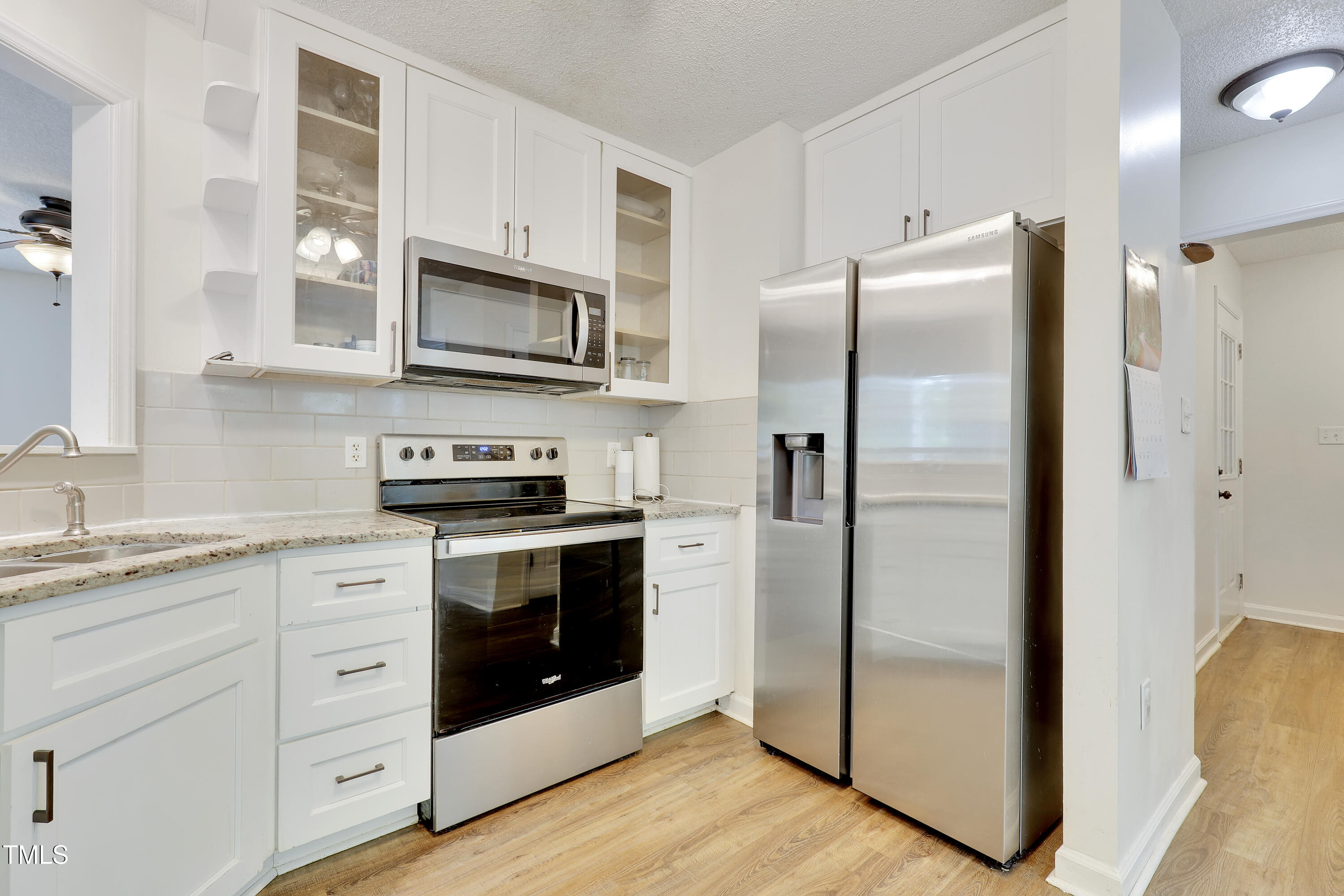 4711 Buttonbush Drive Durham, NC 27712 - Photo 12 of 43 a kitchen with stainless steel appliances granite countertop a refrigerator stove and sink