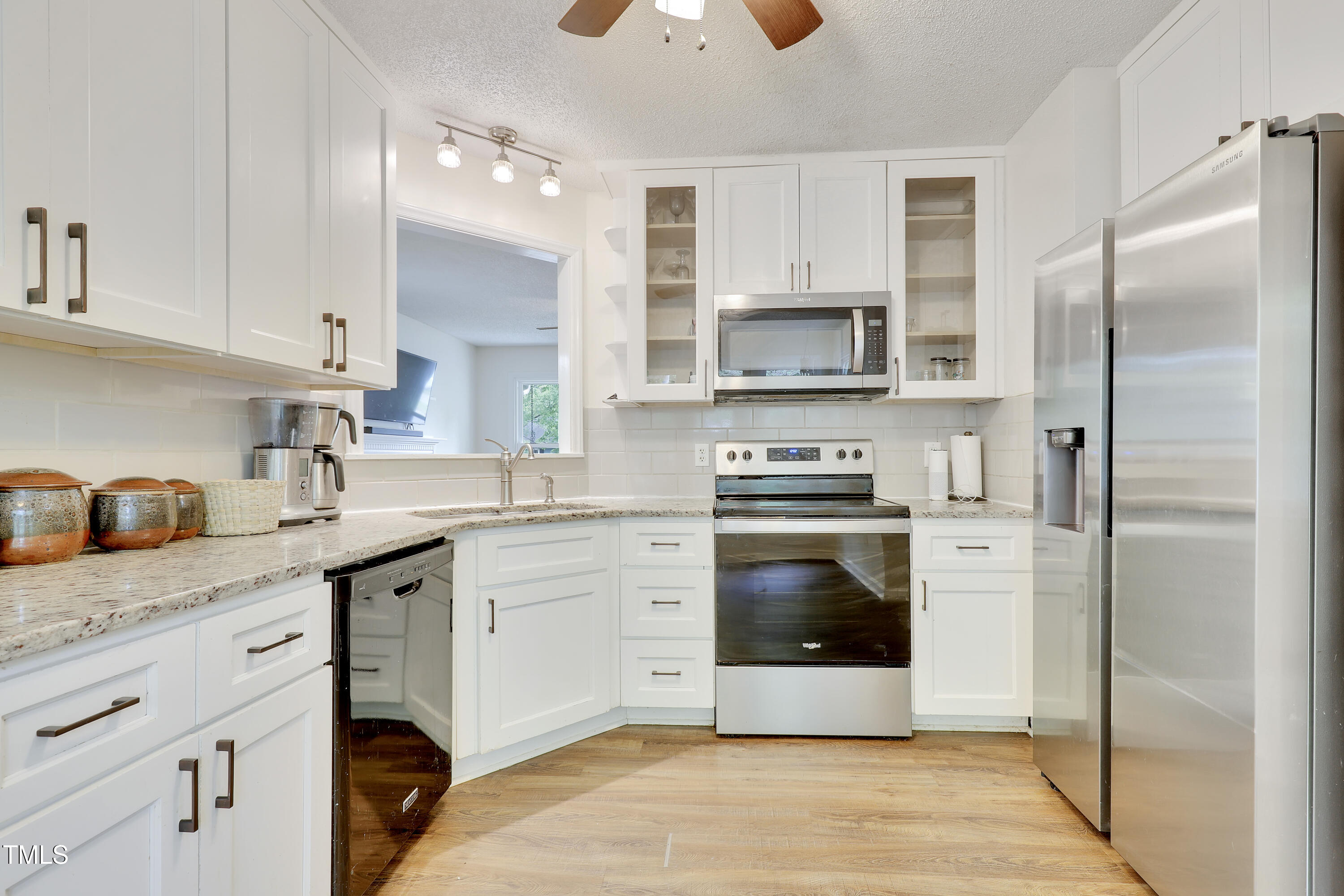 4711 Buttonbush Drive Durham, NC 27712 - Photo 13 of 43 a kitchen with granite countertop a stainless steel appliances cabinets and a sink