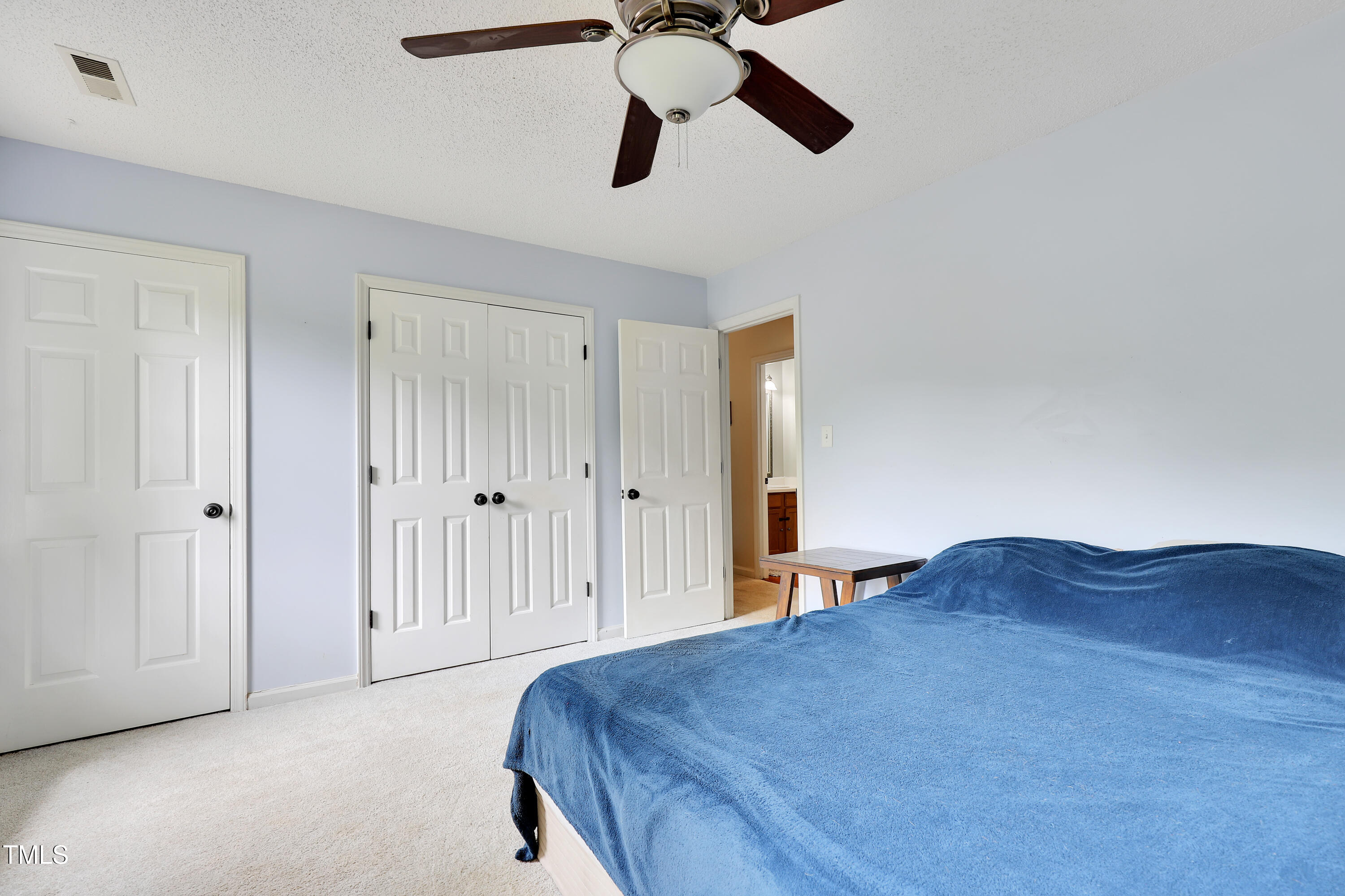 4711 Buttonbush Drive Durham, NC 27712 - Photo 18 of 43 a bedroom with a bed and cabinets