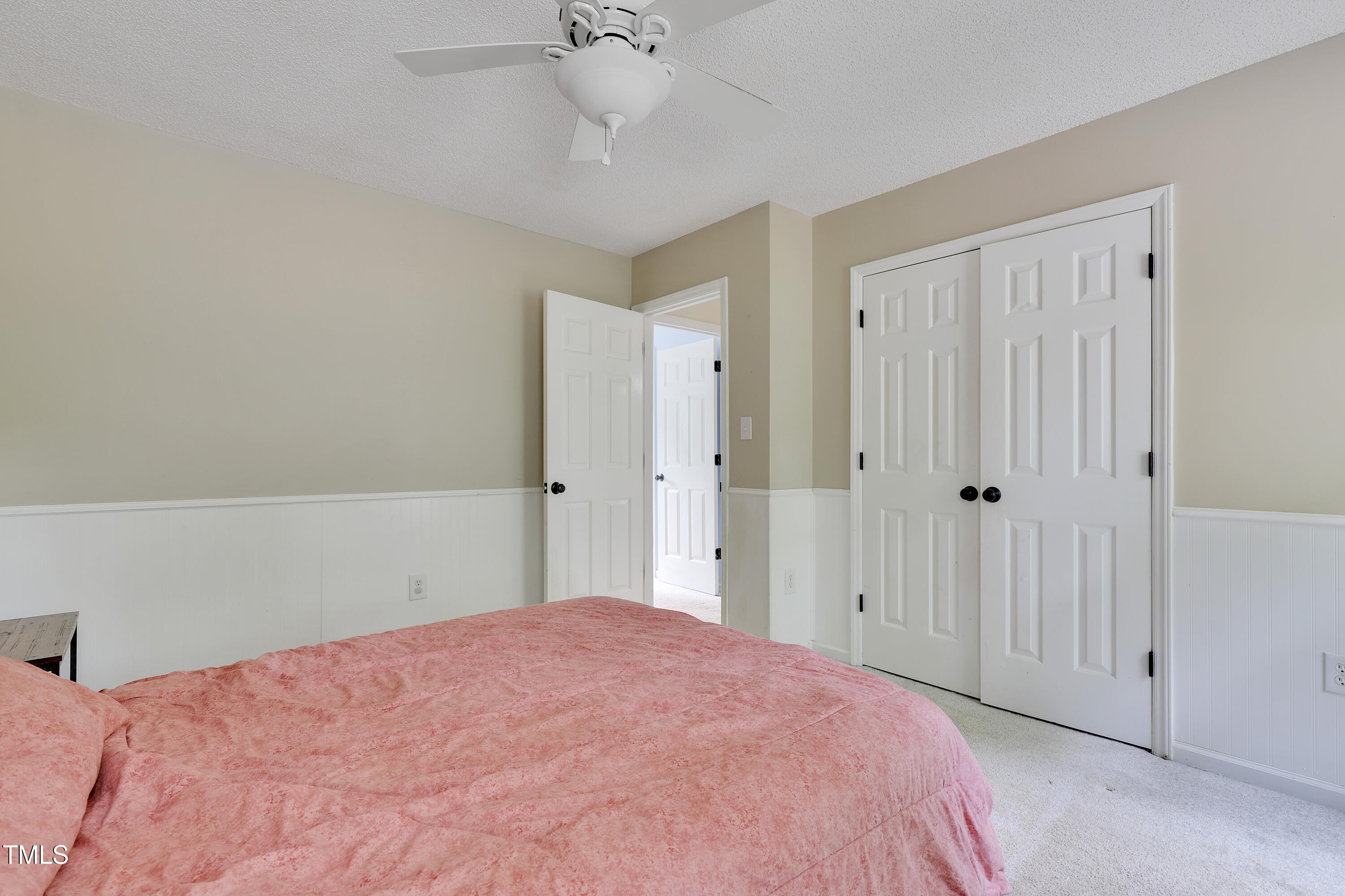 4711 Buttonbush Drive Durham, NC 27712 - Photo 20 of 43 a bedroom with a bed and a chandelier fan