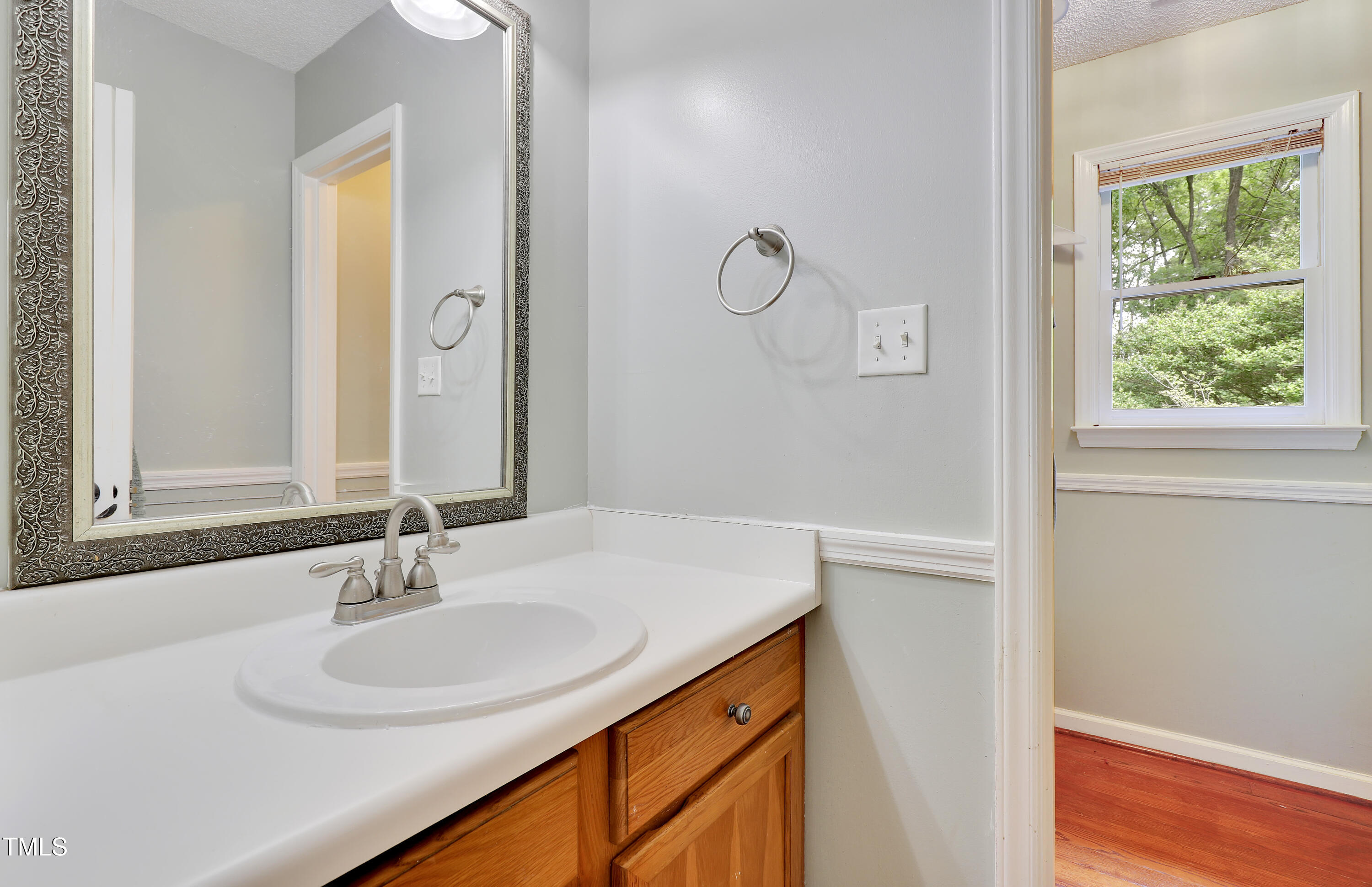 4711 Buttonbush Drive Durham, NC 27712 - Photo 21 of 43 a bathroom with a sink and a mirror