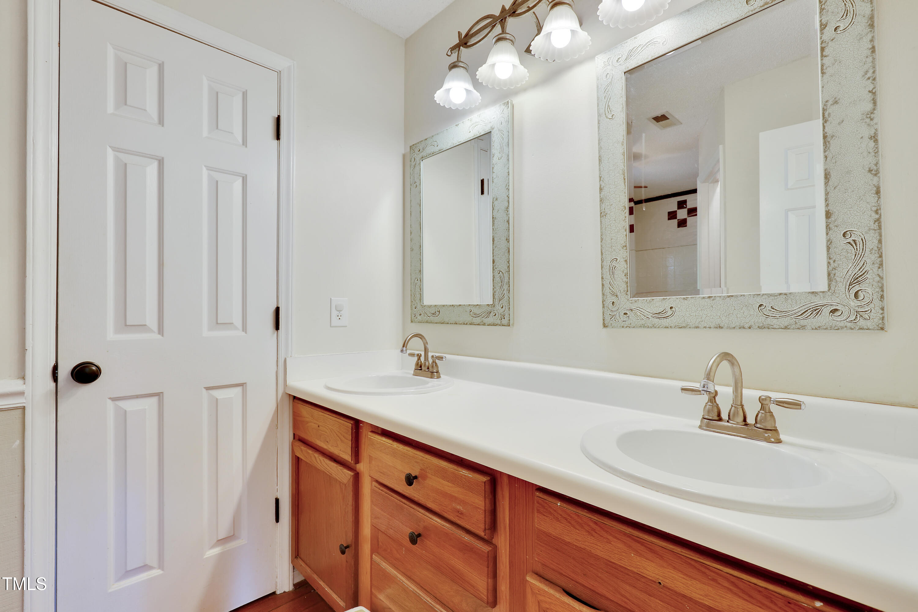 4711 Buttonbush Drive Durham, NC 27712 - Photo 25 of 43 a bathroom with sinks and a mirror