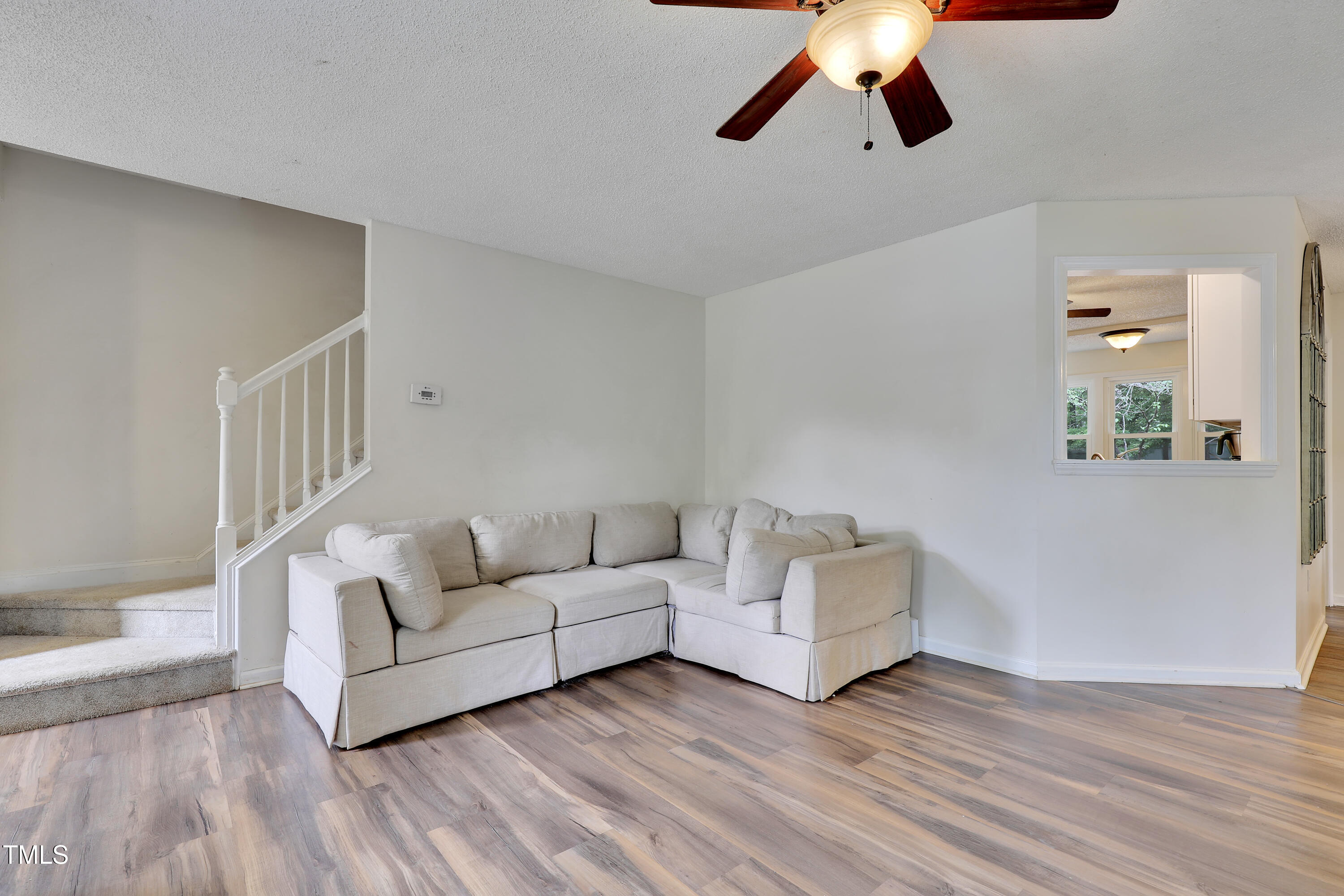 4711 Buttonbush Drive Durham, NC 27712 - Photo 6 of 43 a living room with furniture and a ceiling fan