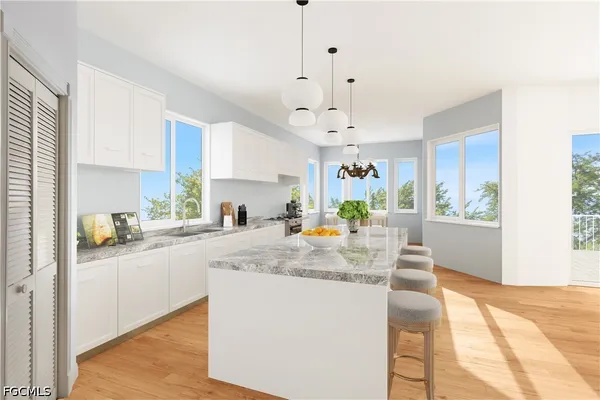 a view of a dining room with furniture a chandelier and wooden floor