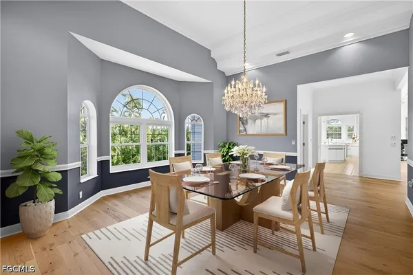 a bedroom with a bed and a chandelier fan