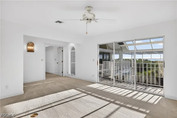 a spacious bedroom with two beds and a chandelier